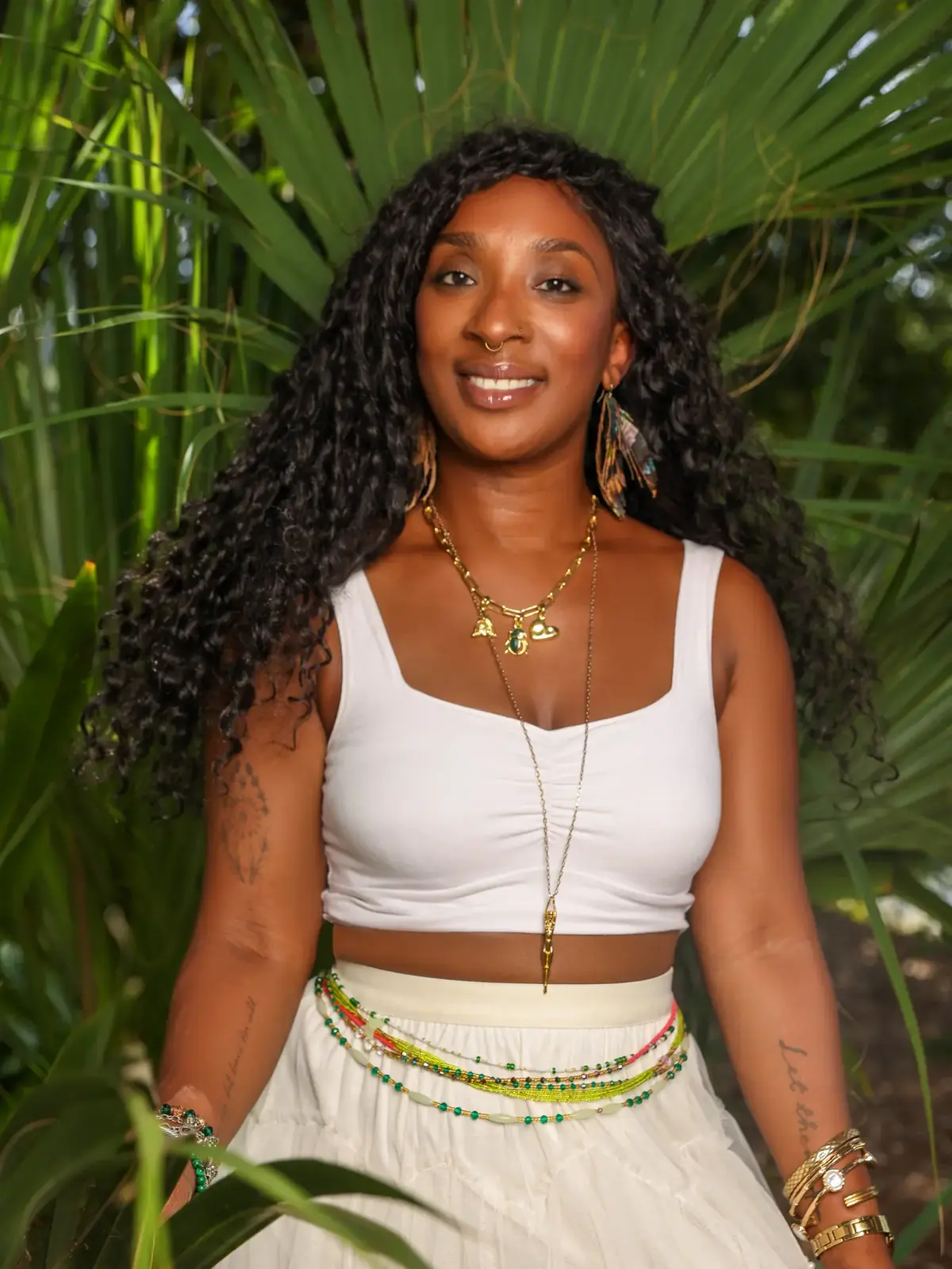 Tieara Dokes smiling among lush green plants